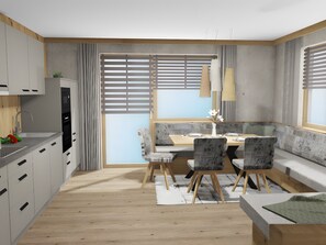 Eine moderne Küche mit Essbereich, Holzboden und einem großen Fenster mit Jalousien.