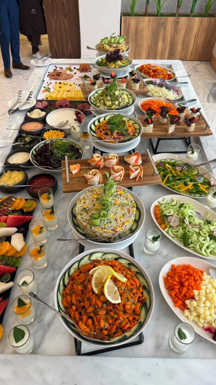A buffet table with various dishes and drinks.