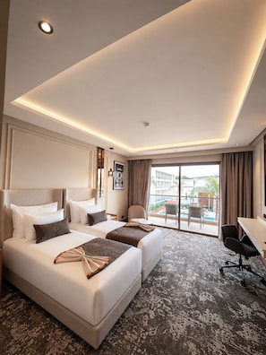 A hotel room with a large bed, a desk, and a view of the outdoors. - Grand Dominium (Agadir)
