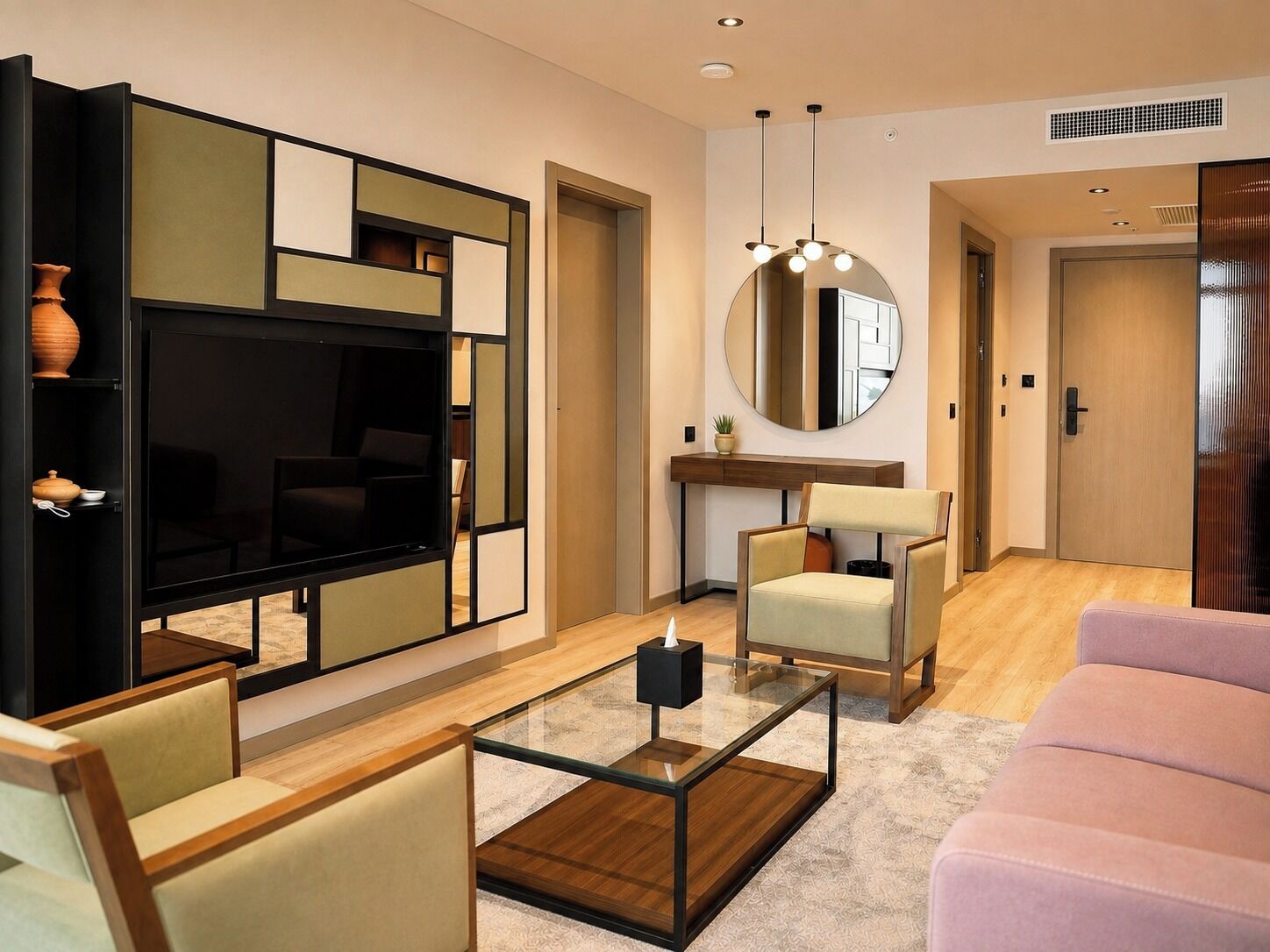 A modern living room with a flat-screen TV, a round mirror, and a glass coffee table.