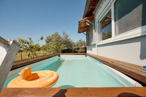 A swimming pool with a wooden deck, a wooden overhang, and a clear sky. - pRETTyHome with private swimming pool,sea view,private parking,bbq,free wifi (χαλκιδικη)