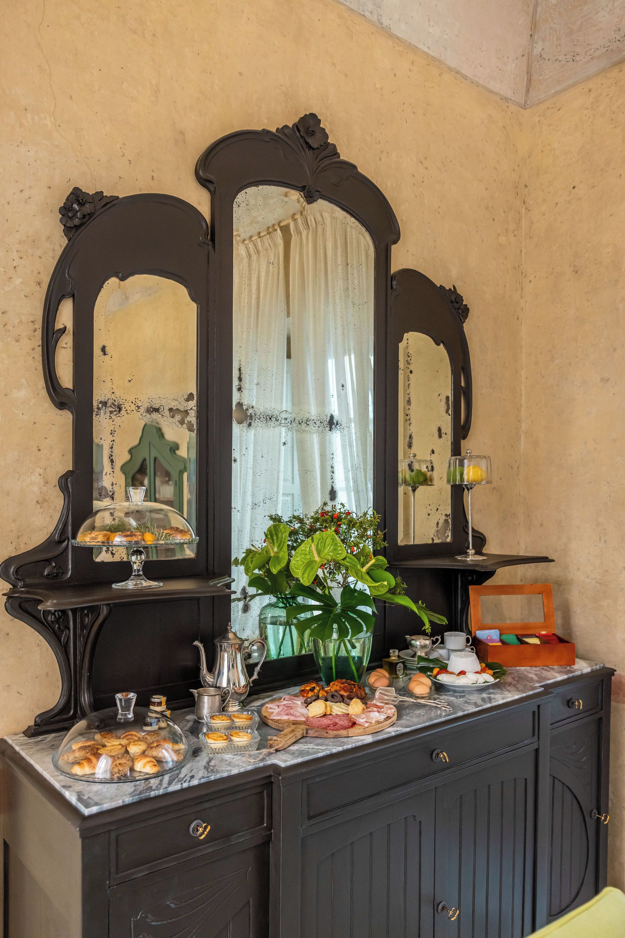 A breakfast buffet with a variety of pastries, meats, and eggs.