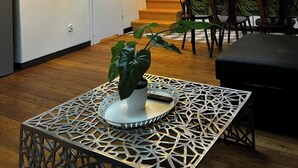 A modern kitchen with a TV, wooden staircase, and a dining area with chairs and a table. - Florianska DeLux Annex 2-bedroom apartment with AC in Old Town Kraków (Kraków)