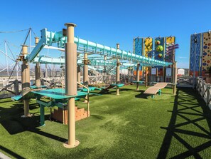 An outdoor play area with climbing structures and slides. - Estuary View (Rochester)