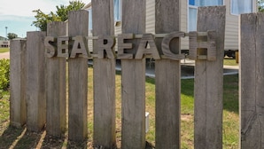 A wooden fence with the word 'SHAREACH' spelled out in large letters.
