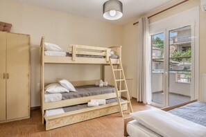 Habitación con literas, un armario y un balcón con vistas.