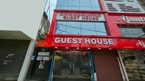 A building with a red sign reading 'ANANDALOKE GUEST HOUSE' and a smaller sign for 'Ajanta Foot Care'. - Anandaloke Guest House (Kolkata)