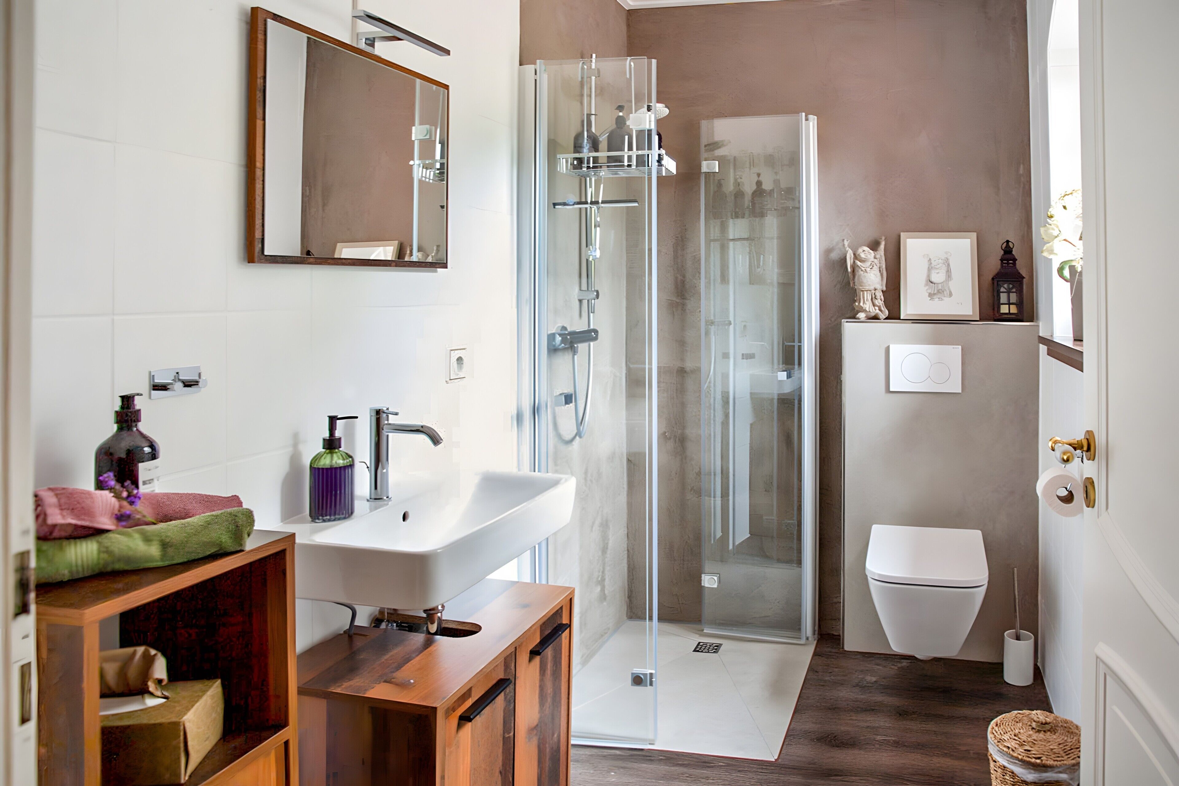 Ein modernes Badezimmer mit Duschkabine aus Glas, einem weißen Waschbecken und einer Toilette.