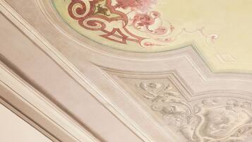 A ceiling with ornate floral and geometric patterns.