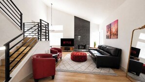 A modern living room with a staircase, a fireplace, a black leather sofa, red armchairs, and a television displaying 'NETFLIX'. - Modern 3BR/3BA Retreat I Spa, BBQ, 15 Min to Strip (Las Vegas)