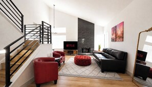 A modern living room with a staircase, a fireplace, a black leather sofa, red armchairs, and a television displaying 'NETFLIX'. - Modern 3BR/3BA Retreat I Spa, BBQ, 15 Min to Strip (Las Vegas)