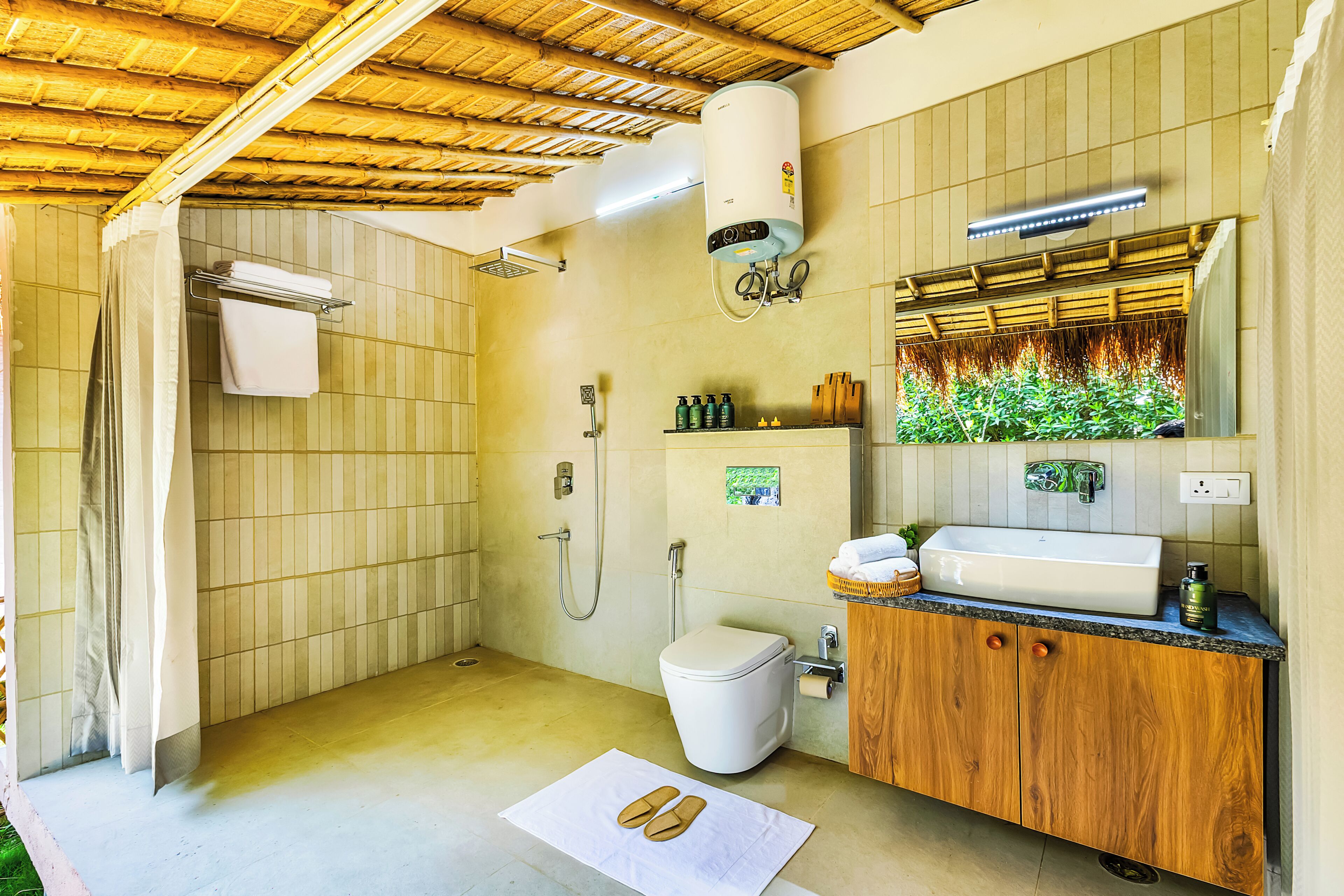 Un baño con ducha, inodoro, lavamanos y toallero.