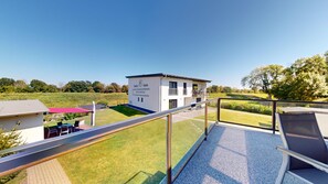 A modern building with a sign for 'Pension - Sauna' and a clear view of a green landscape. - Vacation apartment Oderbruch, directly on the Oder Neisse cycle path (Letschin)
