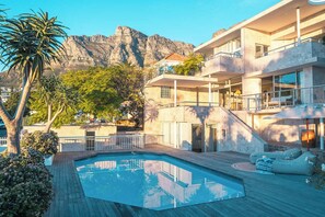 Ein modernes Gebäude mit Pool, Außenbereich und Bergblick.