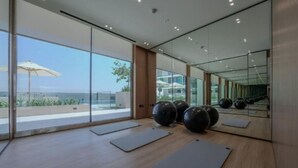 A modern gym with large windows, exercise mats, and large exercise balls. - Sophisticated Studio Escape in JVC  (Dubai)