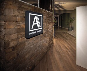 A sign on a brick wall reading 'BOUTIQUE RESIDENCE.' - Alexandra Boutique Residence Seaside  (ALEXANDROUPOLIS)