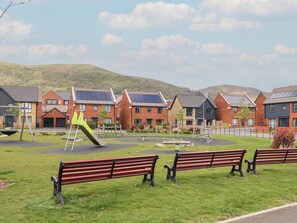 A residential area with houses, a playground, and benches. - Beacon View (Malvern)