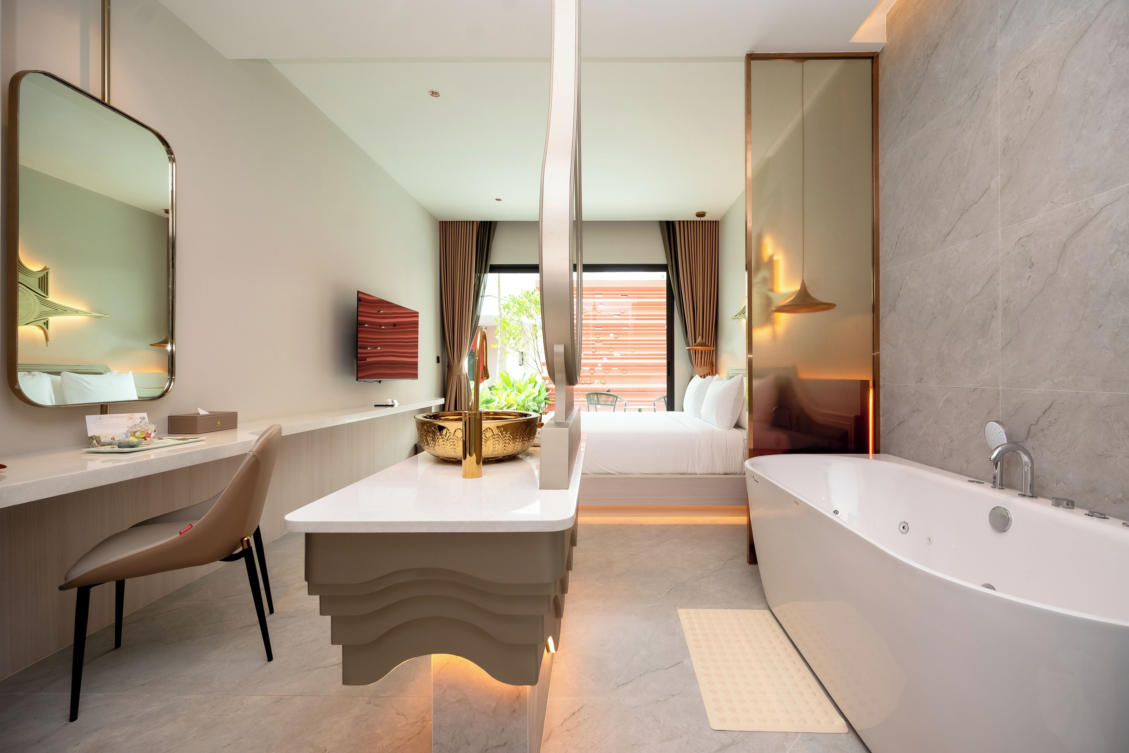 A modern bathroom with a large bathtub, a vanity with a mirror, and a seating area with a view of greenery outside.
