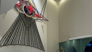 A modern interior with a unique wall design, a curved reception desk, and a minimalist aesthetic. - The Rachata Ayothaya (Ayutthaya)