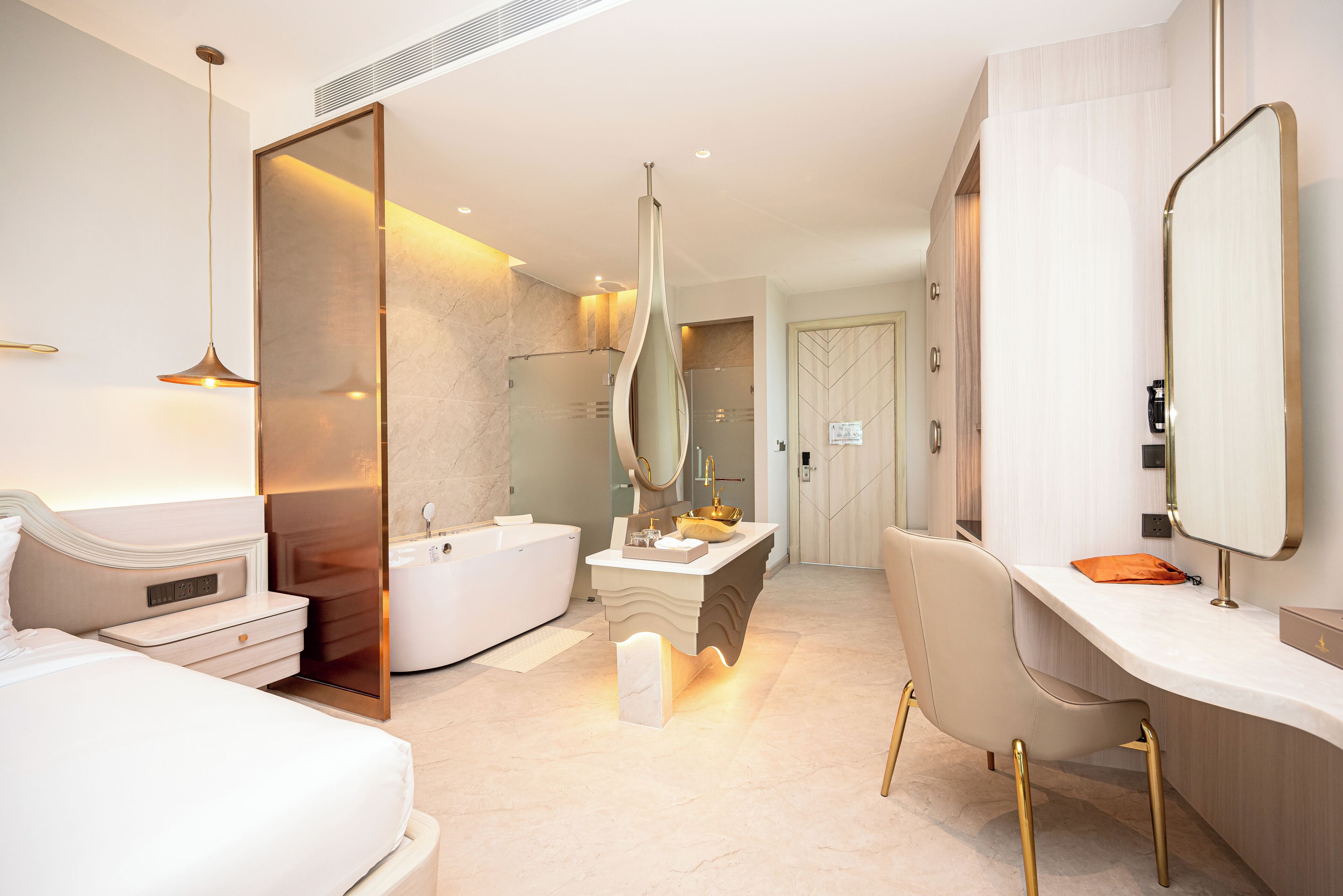 Un baño de hotel moderno con bañera, tocador y un espejo grande.