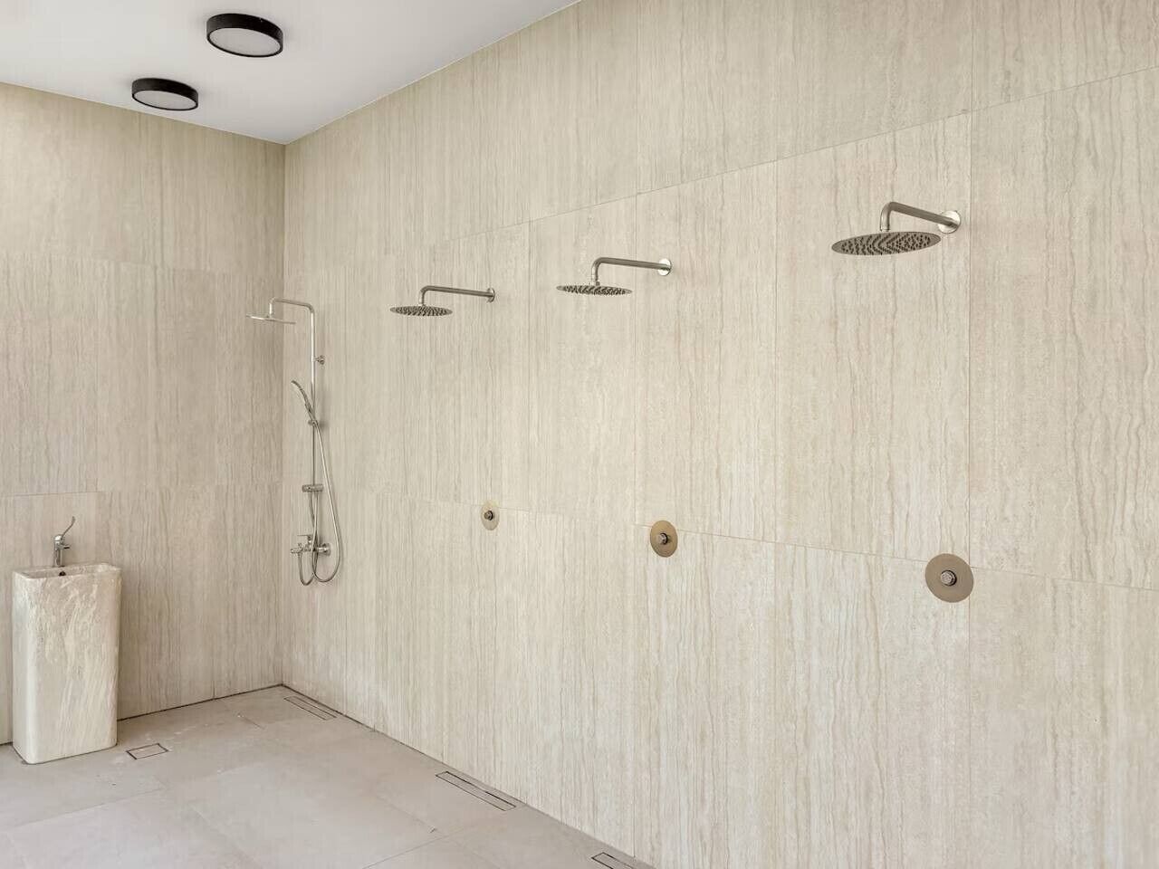 A modern bathroom with a shower, a sink, and a toilet.