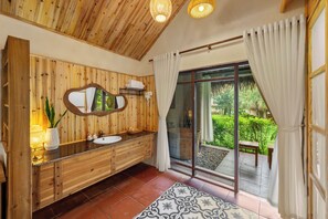 A wooden bathroom with a large mirror, sink, and wooden cabinets. - Cuc Phuong Mineral Retreat (Cuc Phuong)