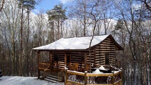 A log cabin with a porch and steps leading up to it, surrounded by a snowy forest. - Peaceful Mountain Cabin with Mt Yonah Views with Fire Pit and Outdoor Dining in Sautee Nacoochee, Georgia (Sautee Nacoochee)