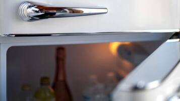A refrigerator with a metallic handle and a glass door.