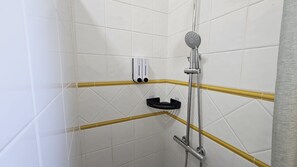 A shower area with white tiled walls, a handheld showerhead, and a black towel rack. - Villa Manantial Country House in the Seville Countryside (La Puebla de Cazalla)