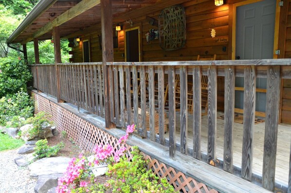 A wooden cabin with a covered porch, a lattice fence, and a sign indicating 'Lodge.' - Cozy Log Cabin for Getaway in the Mountains near Cherokee, North Carolina (Cherokee)