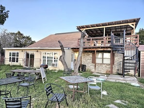 A rustic building with a wooden deck, outdoor seating, and a spiral staircase. - Unique Duplex Rental by Reese Creek for a Weekend Getaway in Texas (Killeen)