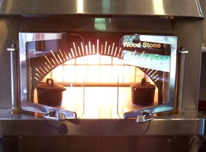 A wood-fired oven with a 'Wood Stone' label, indicating a cooking feature. - Charming Suite Rental with Deluxe Kitchen on Family Farm on Lummi Island (Isla Lummi)