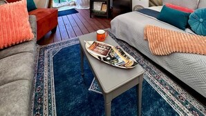 A cozy interior of a tent with a bed, a sofa, a small table, and a lamp. - Serene Teepee Escape with Soulful Ambiance in Salt Lick, Kentucky (Salt Lick)