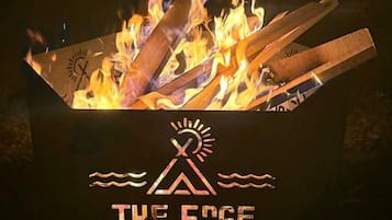 A campfire with a logo and text 'THE EDGE' below it.