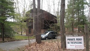 A private road with a sign indicating no trespassing, surrounded by trees and a building. - Family and Pet-Friendly Cabin Rental with a Dock Slip near the Wisp Resort, Maryland (Swanton)