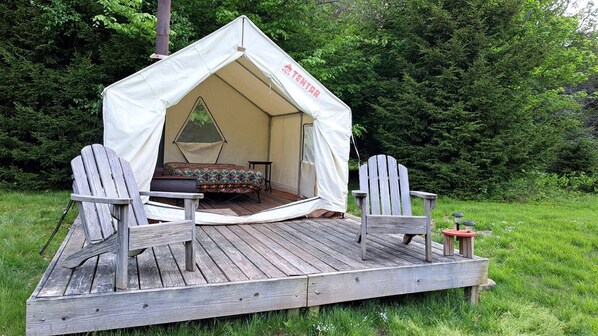 A tent with a bed and two chairs on a wooden deck. - Secluded Glamping Tent with Trout Stream Near Great Northern Catskills in Elka Park, New York (Elka Park)