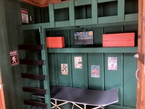A room with a bunk bed, a desk, and a ladder. There are warning signs on the walls. - Scenic Off-Grid Campsite Overlooking Crystal Clear Lake in Sagle, Idaho (Sagle)