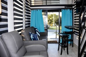 A modern living room with a sofa, a small table, and a chair.