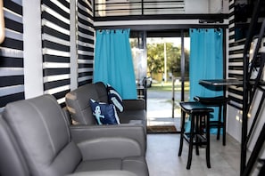 A modern living room with a sofa, a small table, and a chair.