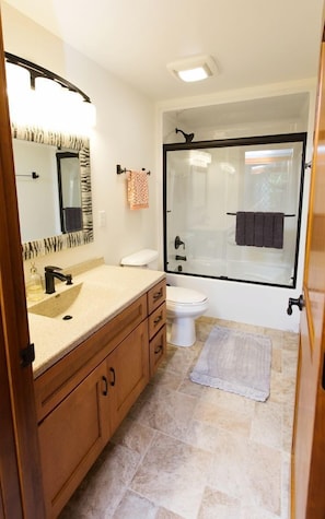 A bathroom with a sink, toilet, and shower. - Beautiful Lakeside Cabin with a Stone Fireplace near Cornucopia, Wisconsin (Ashland)
