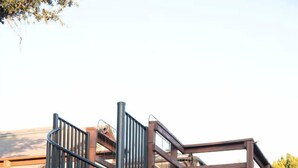 A modern building with a spiral staircase, a stone facade, and a metal fence. - Idyllic Cottage Rental Perfect for an Outdoor Getaway in Killeen, Texas (Killeen)