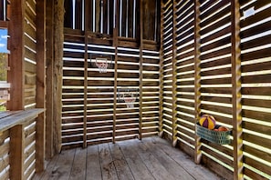 A wooden structure with a basketball hoop and a basket of balls. - Cozy A-Frame Retreat with Creekside Hammock Getaway in Newport, Tennessee (Newport)