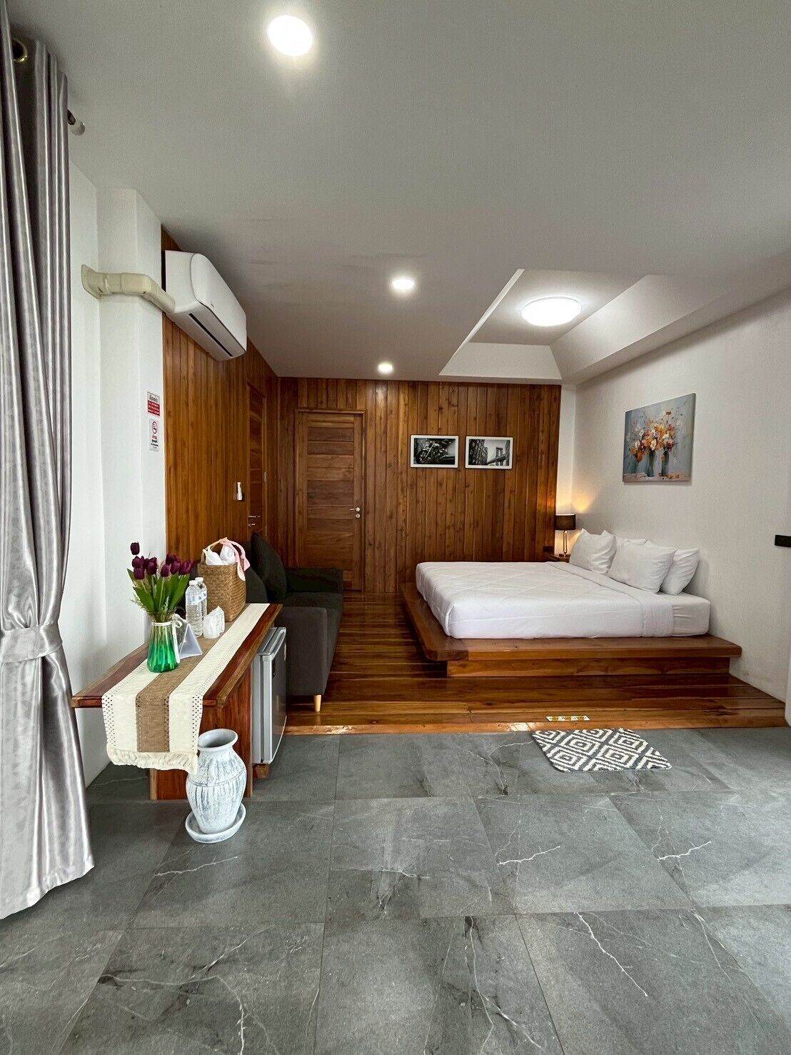 A modern room with a bed, a desk, and a chair.