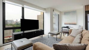 A modern living room with a large window, a flat-screen TV, a sofa, and a small table. - w Amazing 2BR w/ AC in the Heart of Cuauhtémoc (Mexico City)
