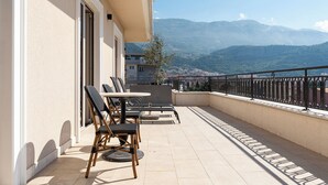 A balcony with outdoor seating, a view of mountains, and a railing. - Hotel Eden (Budva)