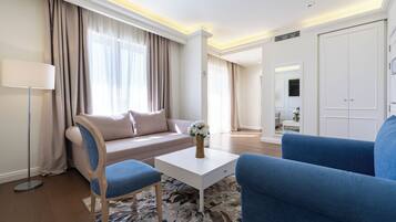 Deluxe Apartment | Living area | 50-inch Smart TV with satellite channels