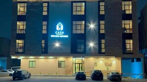 A building with a sign reading 'CASA' and multiple cars parked in front. - Casa Residence Al Narjees (Riyadh, Al Narjis neighborhood)