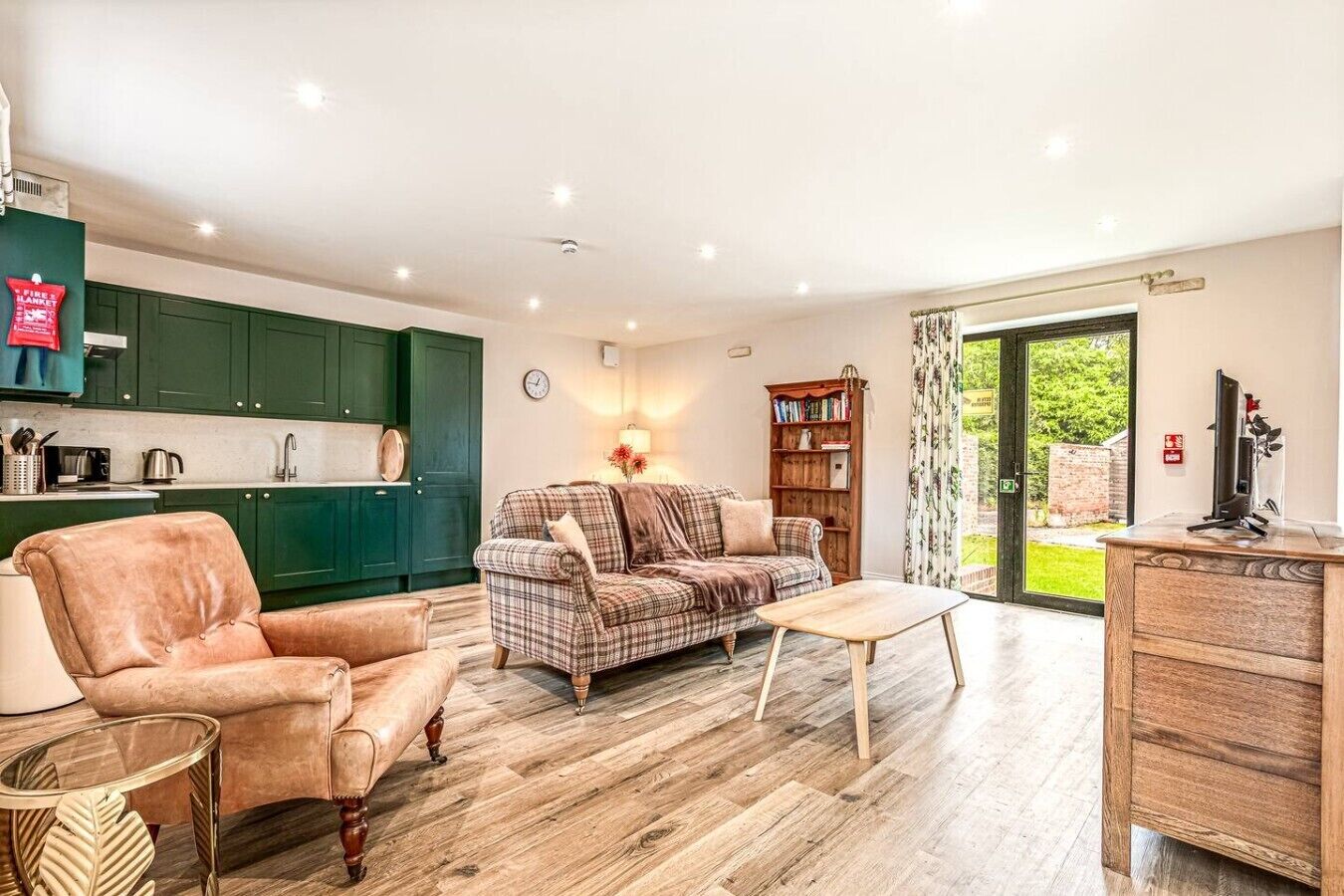 A spacious living area with a sofa, a coffee table, and a TV stand.