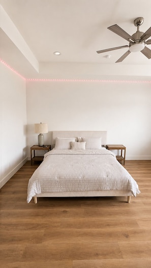 A bedroom with a bed, nightstands, a ceiling fan, and LED strip lighting. - Conveniently located Spacious Houston Heights Home-King Suite-Sleeps 6 (Houston)