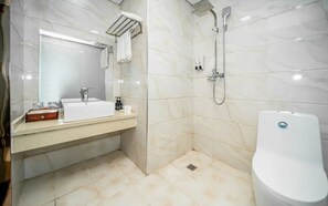 A bathroom with a sink, mirror, towel rack, shower, and toilet.